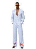 Man wearing a sky blue two piece sets with embroidered orange details